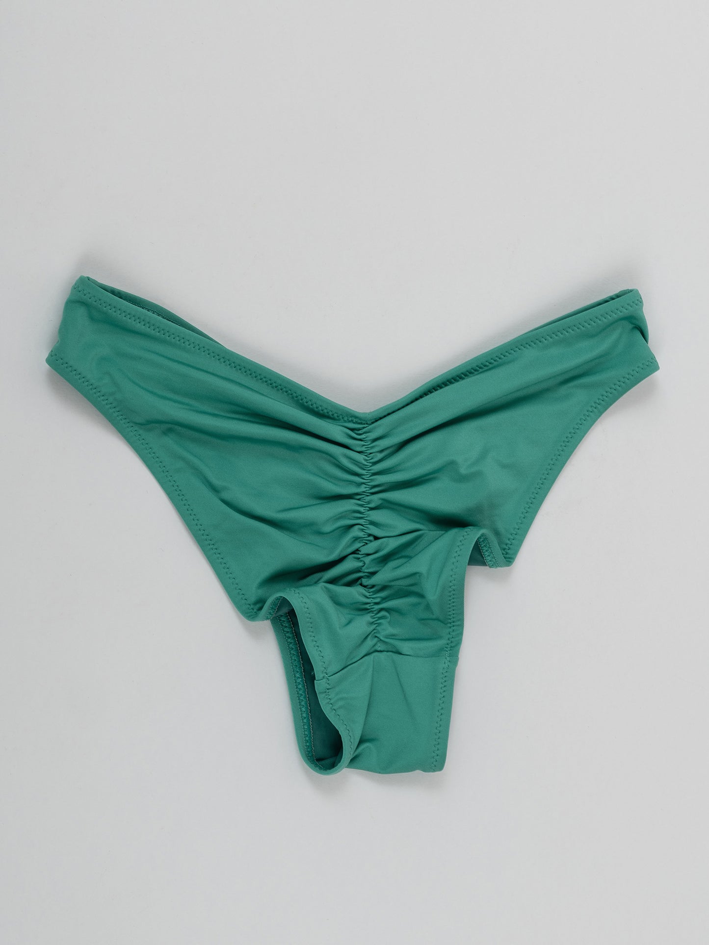 Green pole dance shorts with ruched back detail on white background